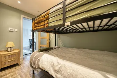 a bedroom with a bunk bed and a lamp at Stylish 3-Bedroom Apartment in Central Glasgow in Glasgow