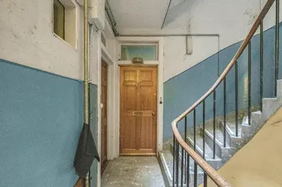 an empty hallway with a wooden door and stairs at Central, Cozy 2BR-1BA-Haymarket - with Parking in Edinburgh