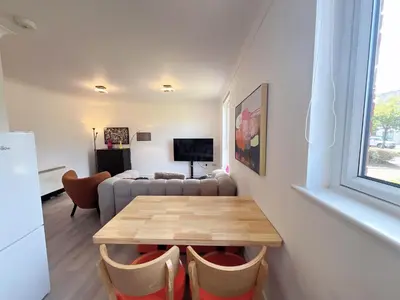 a living room with a table and a couch at Quiet 2 bedrooms and 2 bathrooms with free parking in Edinburgh