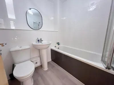 a bathroom with a toilet and a sink and a bath tub at Quiet 2 bedrooms and 2 bathrooms with free parking in Edinburgh