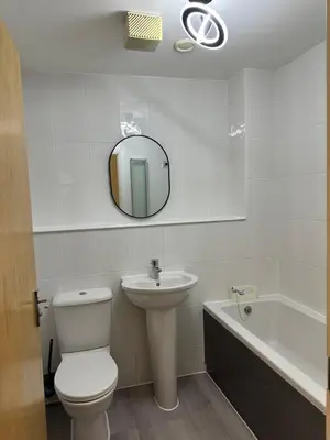 a bathroom with a toilet and a sink and a mirror at Quiet 2 bedrooms and 2 bathrooms with free parking in Edinburgh