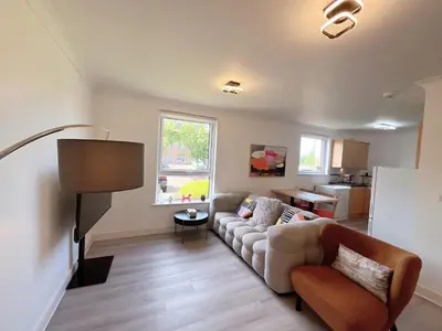 a living room with a couch and a table at Quiet 2 bedrooms and 2 bathrooms with free parking in Edinburgh