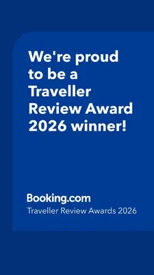 a blue sign that says were proud to be a traveller reviewagency winner at Spacious 3 bed flat- Free parking Edinburgh & Fife in Inverkeithing