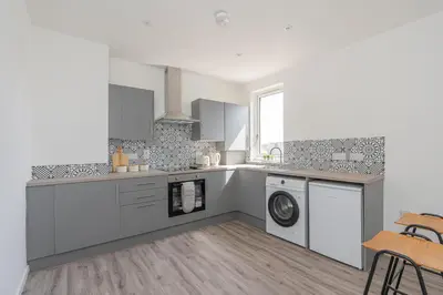 a kitchen with a washer and dryer at Spacious 3 bed flat- Free parking Edinburgh & Fife in Inverkeithing