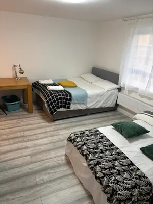 a bedroom with two beds and a desk with a table at private Studio with its own kitchen and bathroom in Moffat