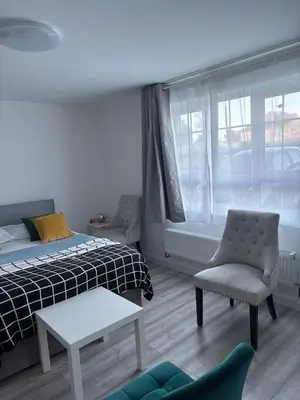 a bedroom with a bed and a chair and a window at private Studio with its own kitchen and bathroom in Moffat