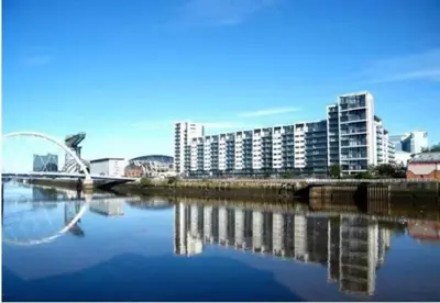 a view of a river with a bridge and buildings at Apartment with river view next to hydro in Glasgow