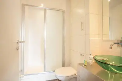 a bathroom with a shower and a toilet and a sink at Apartment with river view next to hydro in Glasgow