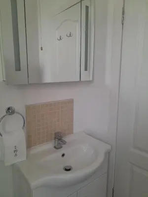 a white bathroom with a sink and a mirror at Doune 3 Outlander Apartment 1st floor in Stirling