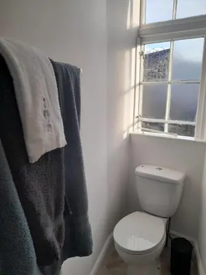 a bathroom with a white toilet and a window at Doune 3 Outlander Apartment 1st floor in Stirling