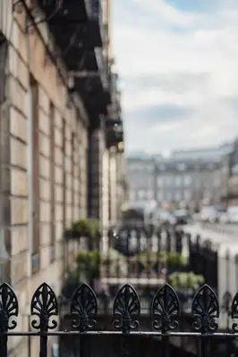a black fence in front of a building at Prestigious Townhouse close to Princes Street in Edinburgh