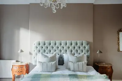 a bedroom with a large white bed with white pillows at Prestigious Townhouse close to Princes Street in Edinburgh