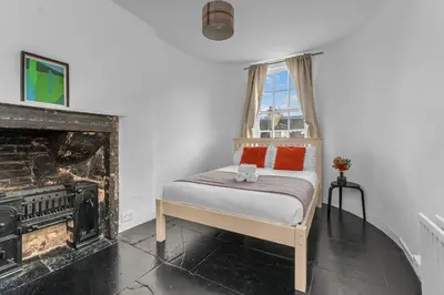 a bedroom with a bed and a fireplace at Super Spacious 4 Bed, sleeps 6 in Edinburgh