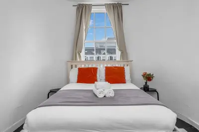 a bedroom with a bed with two towels on it at Super Spacious 4 Bed, sleeps 6 in Edinburgh