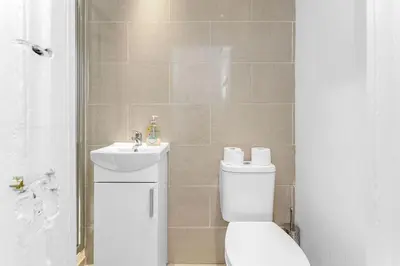 a bathroom with a toilet and a sink at Super Spacious 4 Bed, sleeps 6 in Edinburgh