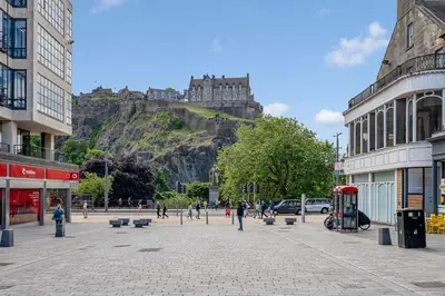 a city with a castle on top of a mountain at Super Spacious 4 Bed, sleeps 6 in Edinburgh