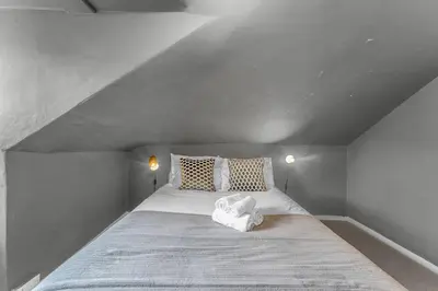 a bedroom with a large bed in a attic at Super Spacious 4 Bed, sleeps 6 in Edinburgh