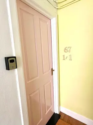 a door in a room with a number on the wall at Small Cosy Flat in Helensburgh