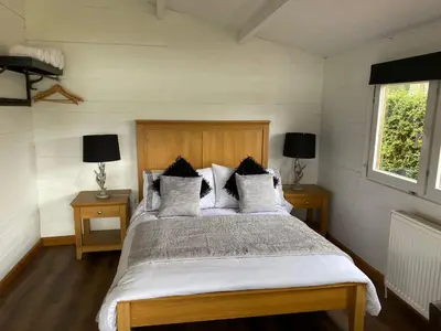 a bedroom with a large bed with white sheets and pillows at Lochside-1Bed-Pet Friendly-Amazing views in Alexandria