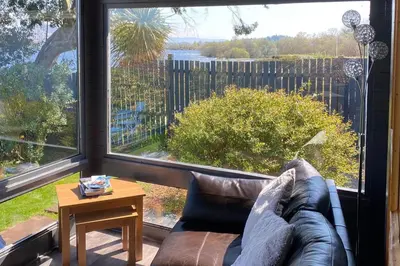 a living room with a couch and a large window at Lochside-1Bed-Pet Friendly-Amazing views in Alexandria