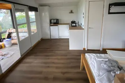 a kitchen with white cabinets and a table in a room at Lochside-1Bed-Pet Friendly-Amazing views in Alexandria