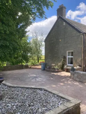 a patio outside of a stone house at Marshill Farmhouse in Blackwood