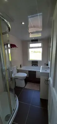 a bathroom with a toilet and a sink at Marshill Farmhouse in Blackwood