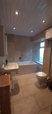 a bathroom with a tub and a toilet and a sink at Marshill Farmhouse in Blackwood