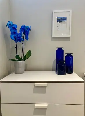 a counter with two blue vases and a plant on it at Park Mews Glasgow in Glasgow