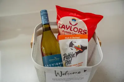 a basket with a bottle of wine and a bag of dog food at 3 Bed in Fearnan oc-s29984 in Chesthill