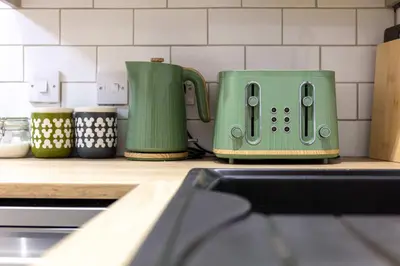 a green toaster sitting on a counter in a kitchen at The Annick Suite No1 - Donnini Apartments in Irvine