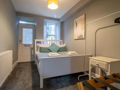 a small bedroom with a white bed and a window at Happy Haven Home, West End - Pass the Keys in Glasgow