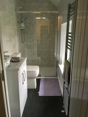 a bathroom with a shower and a toilet and a sink at Farmhouse in Clydebank