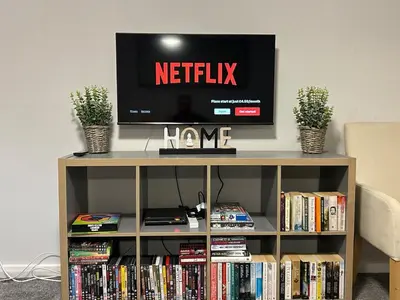 a television on top of a book shelf with books at Spacious 2 bedroom apartment, entire place in Greenock
