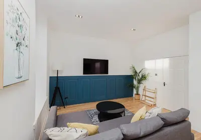 a living room with a couch and a tv at Argyl - Grassmarket Apartments in Edinburgh