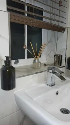 a white sink in a bathroom with a window at Luxurious Cottage Machrihanish in Drumlemble