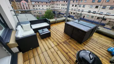 a balcony with a table and a tub on a building at Modern Room in a Shared Flat near Haymarket in Edinburgh