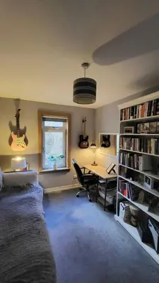 a bedroom with a bed and a desk and a window at Cosy 2 bed home Glasgow South in Cathcart