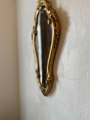 a gold mirror hanging on a wall at 1 Bed Flat Near Edinburgh Castle in Edinburgh