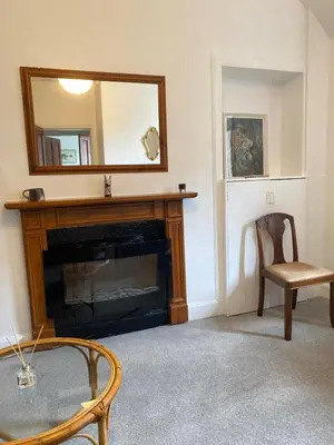 a living room with a fireplace and a mirror at 1 Bed Flat Near Edinburgh Castle in Edinburgh