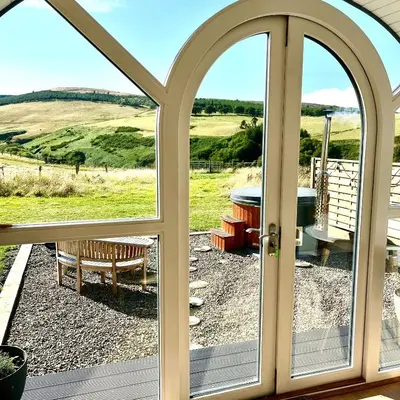 an open door to a patio with a view at Heather Pod in Perth