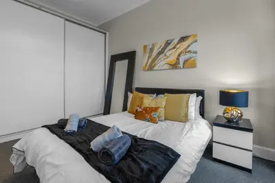 a bedroom with a bed with towels on it at Free Parking - City Centre - Stunning Views - Great Location in Edinburgh