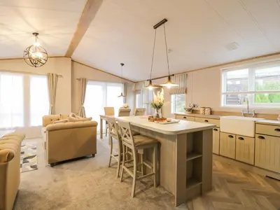 a kitchen with a large island in a room at Debonair Lodge in Newton Stewart