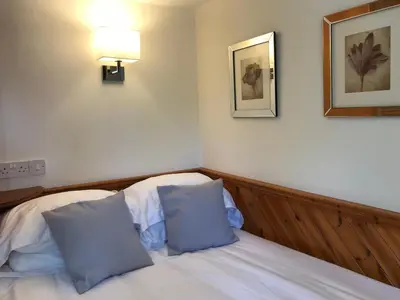 a bedroom with a bed with two blue pillows at STYLISH APARTMENT with PRIVATE ROOF TERRACE in Edinburgh