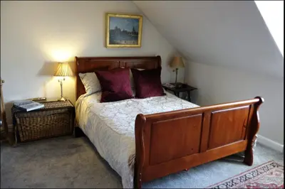 a bedroom with a bed with purple pillows at Stunning 2-Bedroom Georgian Flat, City Centre in Edinburgh