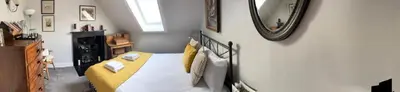 a bedroom with a bed and a mirror on the wall at Stunning 2-Bedroom Georgian Flat, City Centre in Edinburgh