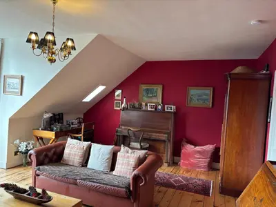 a living room with a couch and a piano at Stunning 2-Bedroom Georgian Flat, City Centre in Edinburgh