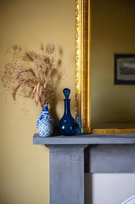 two blue vases sitting on a table in front of a mirror at 7 Crown Gardens Glasgow in Glasgow