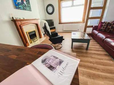 a living room with a couch and a table at 20min to Edinburgh City Centre Scotland Gateway in Cowdenbeath