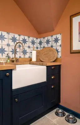 a kitchen with a sink and blue and white tiles at The Unique Cathedral Hideaway in Stirling